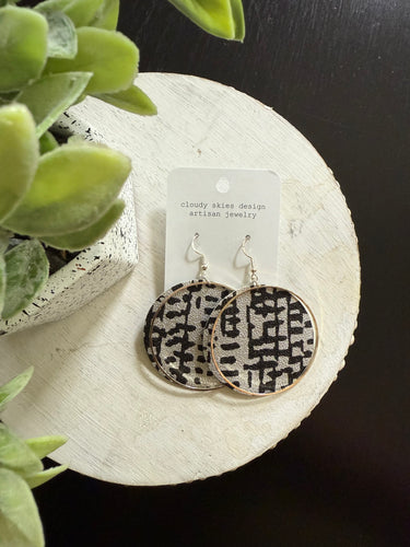 fun wallpaper that is black and silver with silver metal accent earring